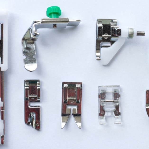 Eight different kinds of sewing machine presser feet neatly arranged on a white background.